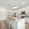 Spacious kitchen with stainless steel appliances, white cabinetry, and a large island