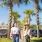 two women walk down a tree lined walkway
